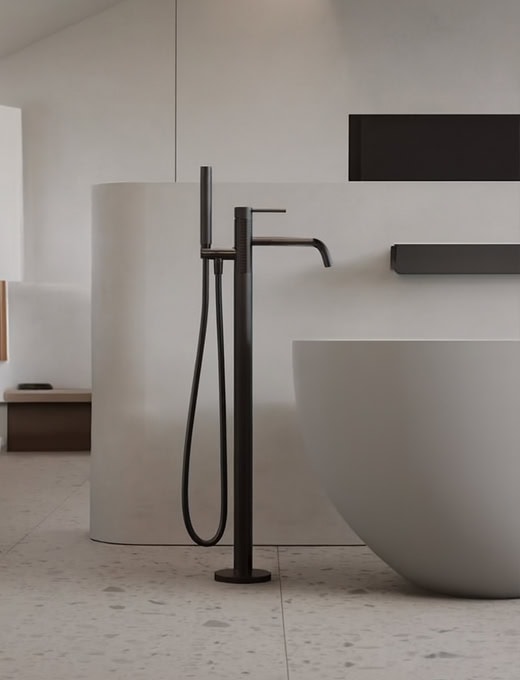 A-Torneira modern black freestanding bathroom faucet with handheld shower in minimalist bathroom design.