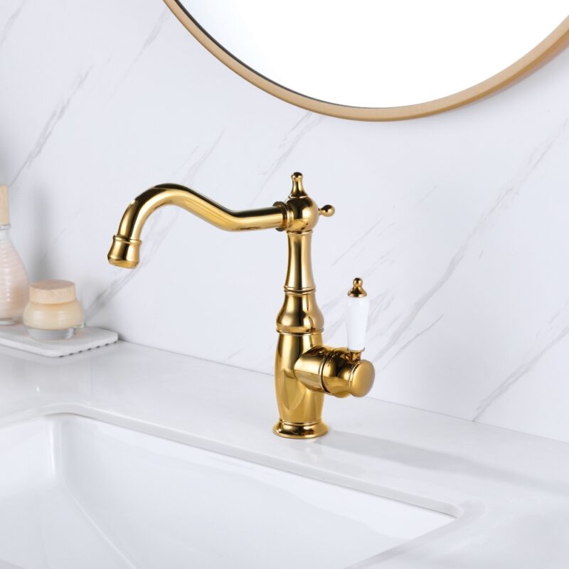 Luxurious gold vintage kitchen faucet on white marble countertop.