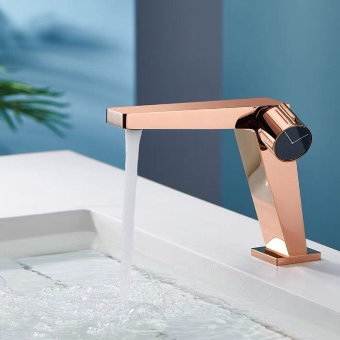 Elegant rose gold kitchen or bathroom faucet with modern design and water flow.