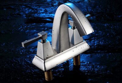 Modern stainless steel kitchen faucet with water droplets on dark textured background.