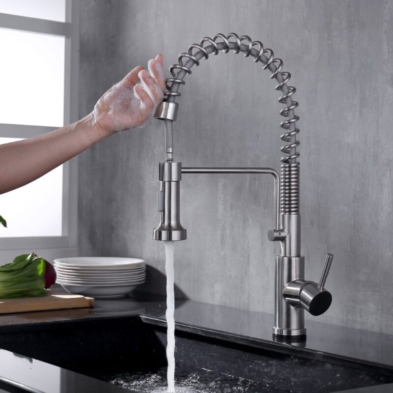 Stainless steel kitchen faucet with flexible spring hose for easy water control and modern design.