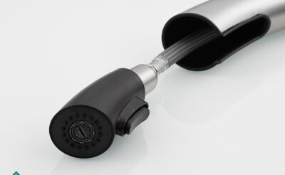 Flexible kitchen faucet spray head with ergonomic design for effective water flow control.