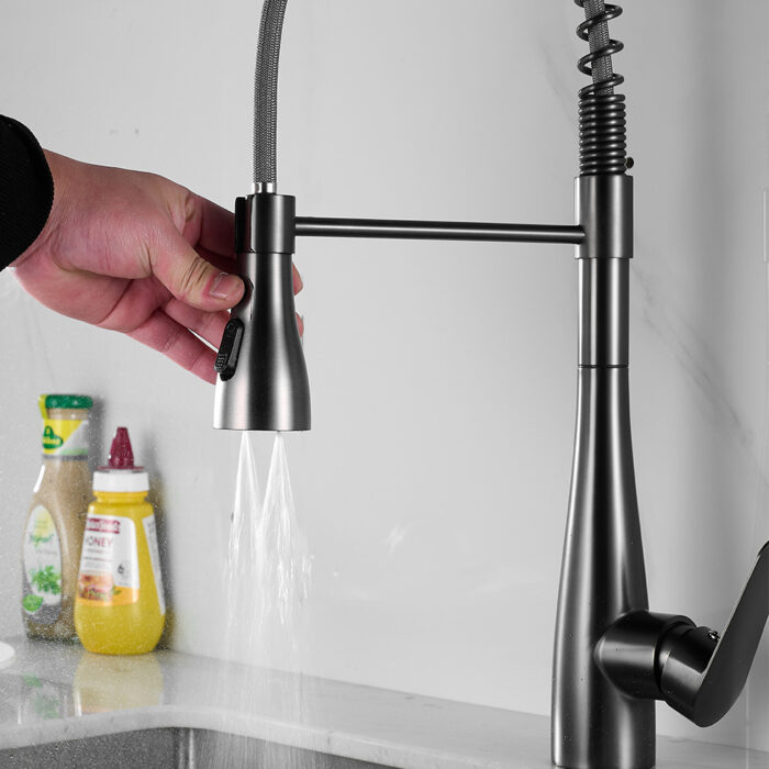 Sleek stainless steel kitchen faucet with pull-down spray head, modern design, and water flow control.
