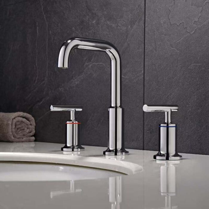 Sleek modern chrome kitchen faucet with dual handles for hot and cold water.