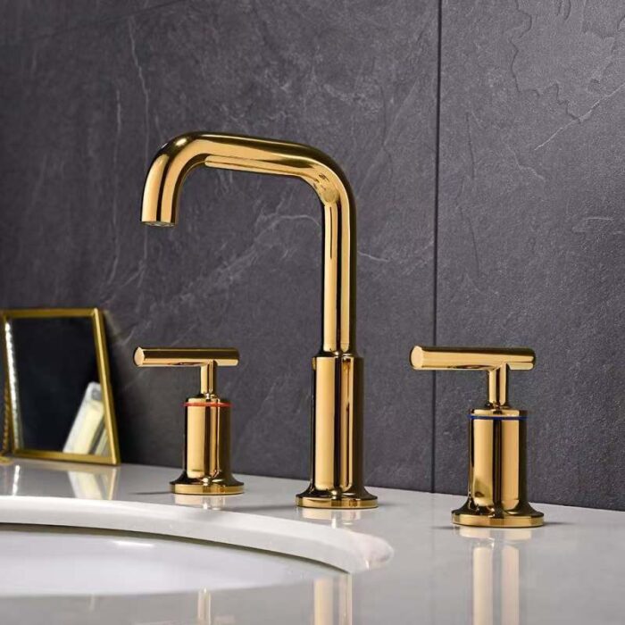 Gold modern kitchen faucet with matching handles, elegant design, high-end fixtures, and sleek style for luxury kitchens.