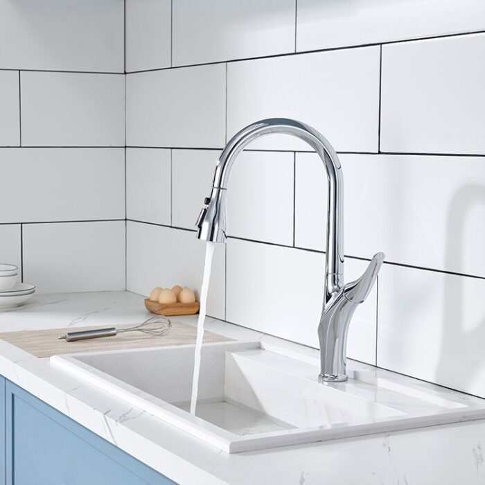 Shiny chrome kitchen faucet with running water and white tiled backsplash for modern kitchen decor.