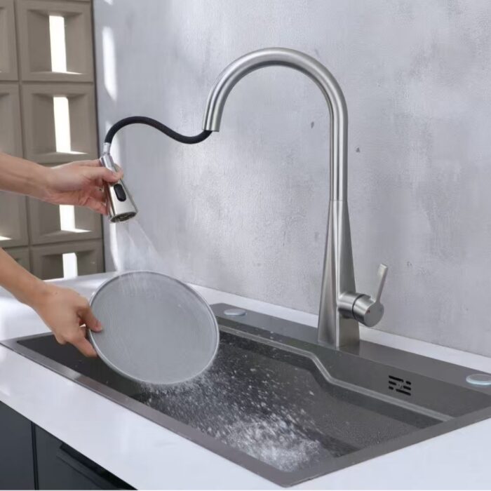 Sleek modern kitchen sink with high-arc faucet and pull-down spray head for versatile cleaning and cooking tasks.