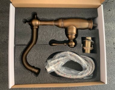 Vintage bronze kitchen faucet with flexible hose and installation accessories for modern or classic sink upgrades.