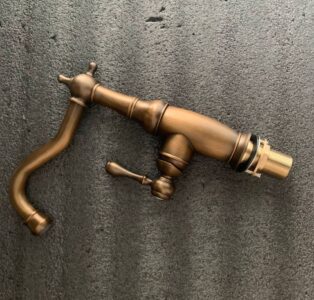 Vintage bronze kitchen faucet with classic design for antique style bathrooms and kitchens.