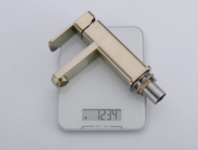 Brass kitchen faucet with modern design on digital scale, lightweight and durable for home use.