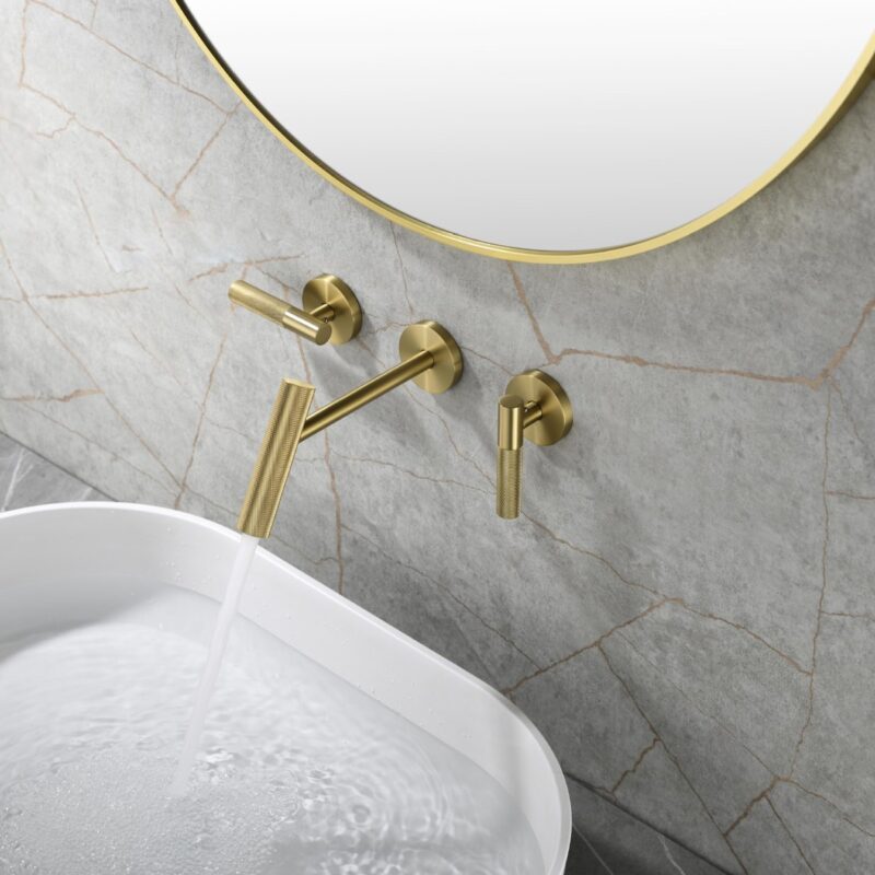 Elegant gold wall-mounted bathroom faucet with matching handles, modern style for luxury sink decor.