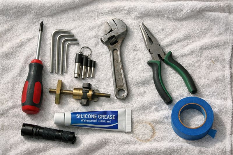 Tool checklist for replacing a shower faucet, including a small flashlight and cartridge puller