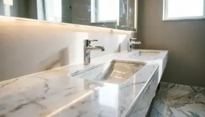 Single-hole chrome hotel bathroom faucet installed on marble countertop