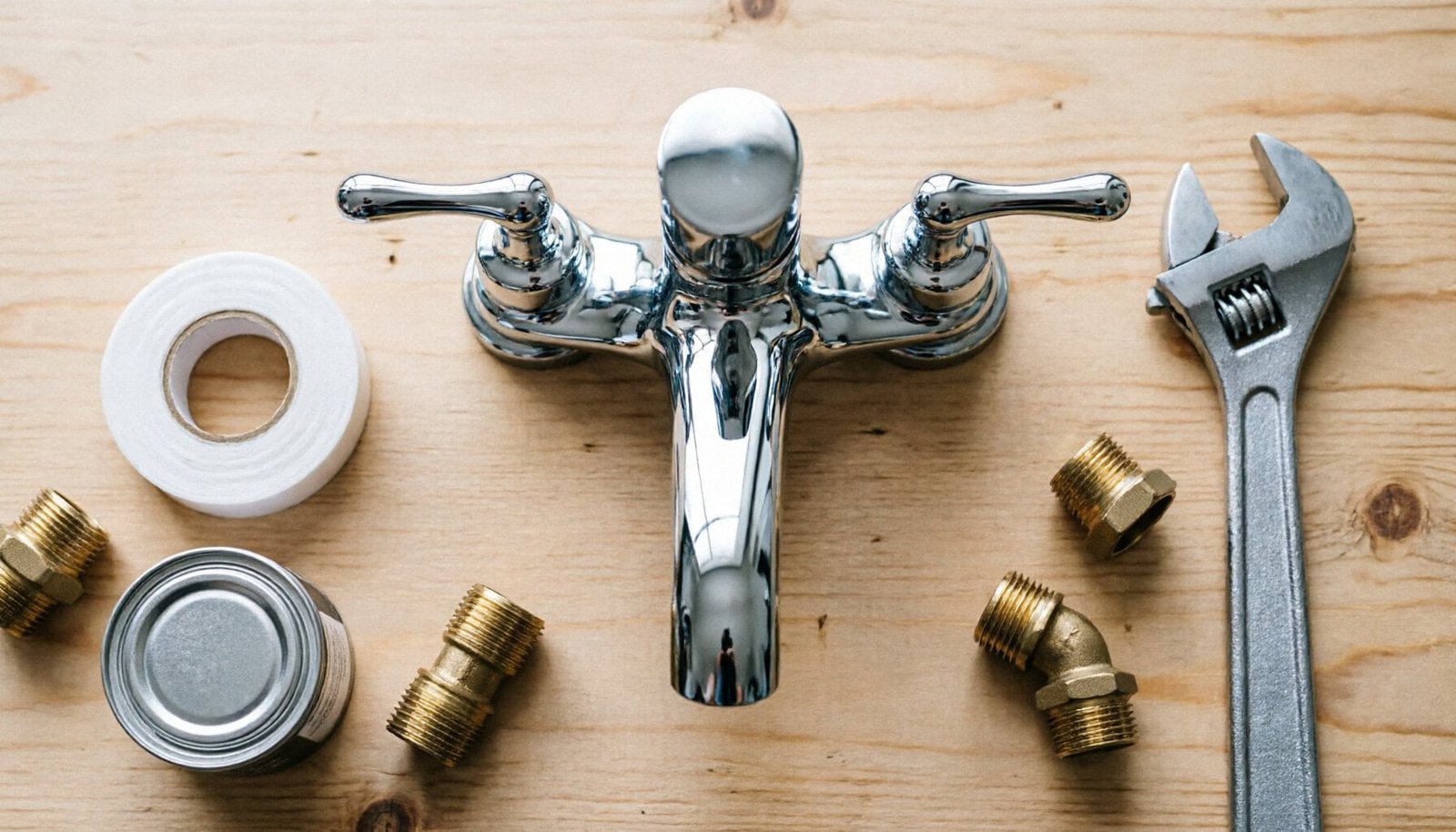 Bathroom faucet installation tools on wooden workbench