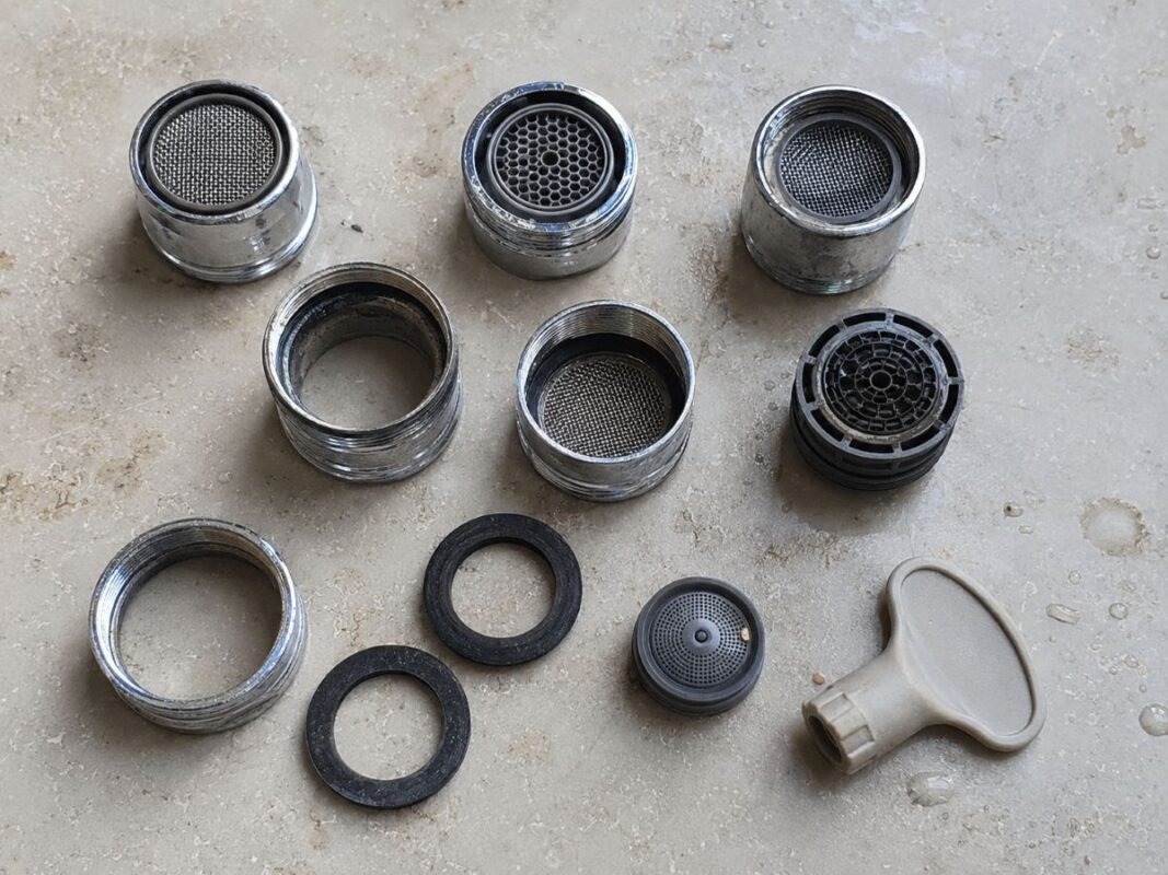 Faucet aerator, adapter ring, insert, and rubber washer arranged for pull-out faucet repair
